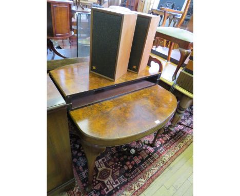 An Art Deco burr walnut veneered wind-out extending dining table, by Maple & Co, complete with two extra leaves, raised on ca