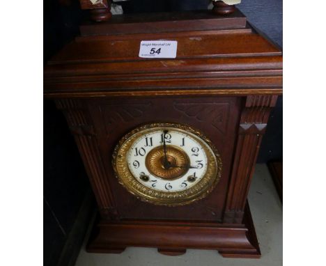A late 19th/early 20th Century continental mantel clock in dark stained wooden case.