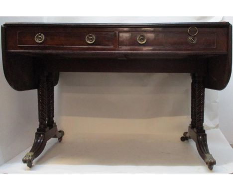 A Regency mahogany sofa table with twin fall flaps, over two in line drawers with facsimiles to the reverse, above four rope-