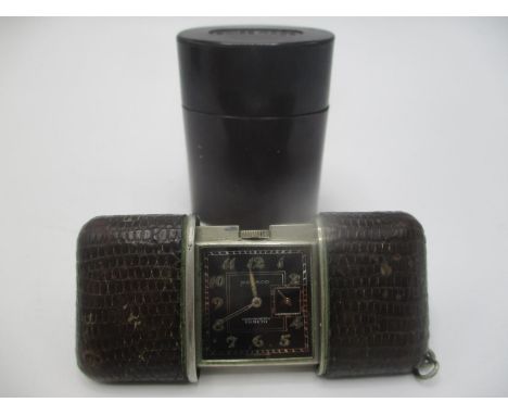 An Art Deco Movado Ermeto chronometer manual wind purse watch having a black dial with subsidary seconds dial at 3, the case 