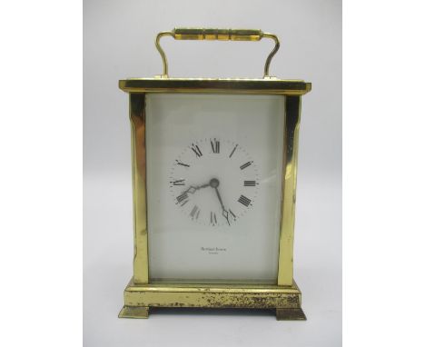 A late 10th century brass ceased carriage clock, the white enamel dial having Roman numerals and signed Shortland Bower. The 