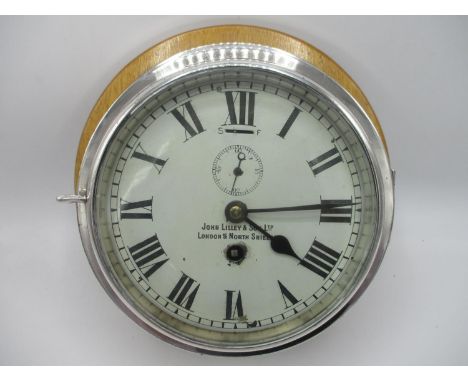 An early 20th century ships clock having a white dial with Roman numerals, the dial inscribed John Lilley &amp; Son Ltd, Lond