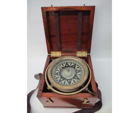 An E Dent &amp; Co London brass cased government issue ships compass circa 1900 with black and off white markers, stamped to 