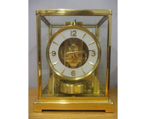 A Jaeger Le Coultre Atmos clock circa 1960, in a gilt brass case, the cream chapter ring with baton and Arabic numerals, seri