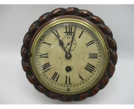 An early 20th century ships clock in an oak rope twist case, the dial having Roman numerals and a subsidary seconds dial, 8 1