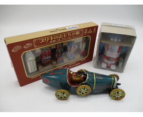 A Japanese boxed wind up Action Mr Atomic tin toy robot by Cragstan, limited edition, 4" h, along with a miniature Toys Club 