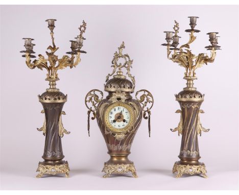 A French Garniture de Chéminé or clock set, consisting of a mantel clock and two five-armed candlesticks.H.: 71 cm. 