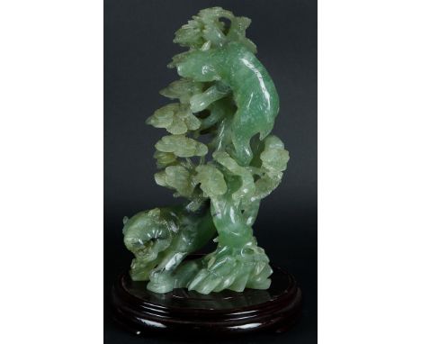 A large Jade statue with decoration of a tiger and a bear near a tree. China, 20th century. H.: 31 cm. (zonder basement).