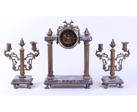 A mantel clock consisting of two candlestick holders and a mantel clock. Equipped with gray marble. Approx. 1900. H.: 40,5 cm
