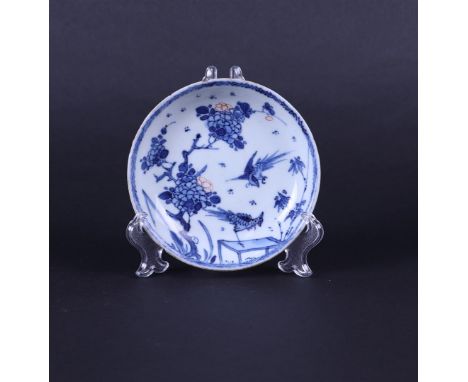 A porcelain partly polychrome plate with a decoration of pheasants. China, Early Kangxi,Diam. 11,5 cm.