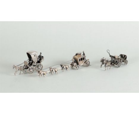 A lot of miniature silver consisting of a model of a royal carriage pulled by six horses, a beer cart, and a carriage. All 2n