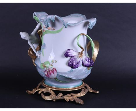 A porcelain Art Noveau style vase with brass base, marked Sèvres.26 x 22 cm.