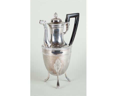 A silver jug on three high legs, with an acorn-shaped knob on the lid and with rich leaf decoration and pearl edge, the spout