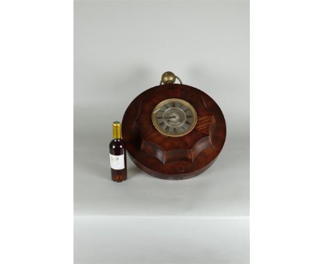 A large mahogany mantel clock in the shape of a pocket watch.Diam. 40 cm. 