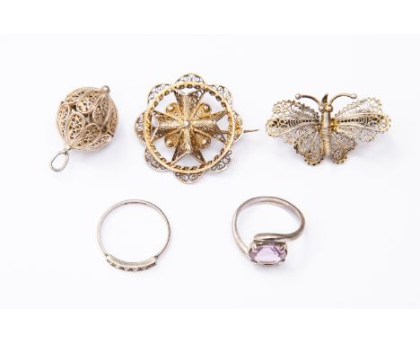 A collection of white metal and silver items to include an amethyst ring, paste set ring and two filigree brooches and a fili
