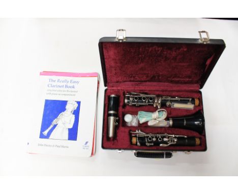 A blessing Clarinet with all extras including new spare reeds, cased, and with four music books