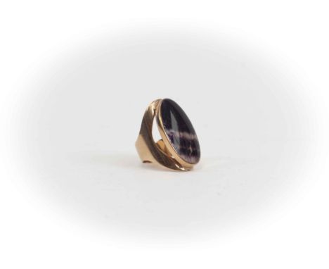 A Blue John and 9ct gold ring, the oval Blue John stone approx size 30mm x 17mm, rub over set with a split shoulder 9ct gold 