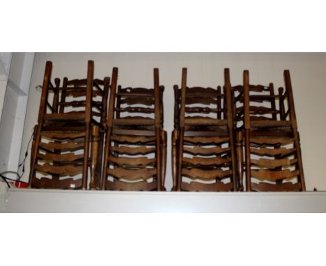 A set of eight oak ladder back chairs, fitted with rush seats