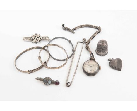 A quantity of Silver jewellery items to include a cloak pin, three bangles, a watch thimble etc
