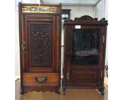 A late Victorian oak smokers cabinet, the top with a pierced brass gallery the door enclosing a single drawer to base, togged