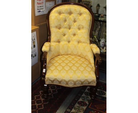 A late Victorian mahogany deep button backed upholstered Gentleman's armchair, with gold patterned upholstery, padded arms an
