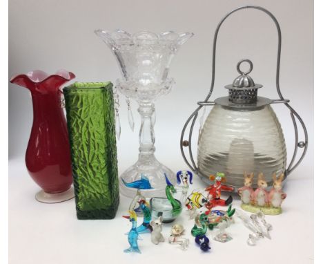 A collection of miniature glass lampwork figures including a clown, owl, dog, dolphin etc together with a ruby glass vase wit