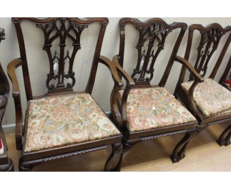 A George III style set of eight mahogany dining chairs, in the manner of Thomas Chippendale, comprising two carvers and six s