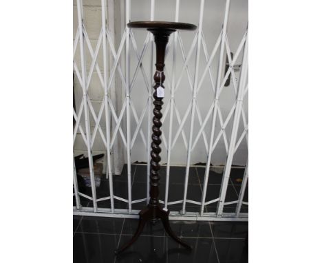 An early 20th Century mahogany torchere, having a barley twist column, a mahogany tripod wine table, a nest of three tables a