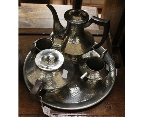 An Art Deco, five piece pewter hammered tea set and coffee set inch coffee pot, teapot, sugar, milk and tray, stamped on base