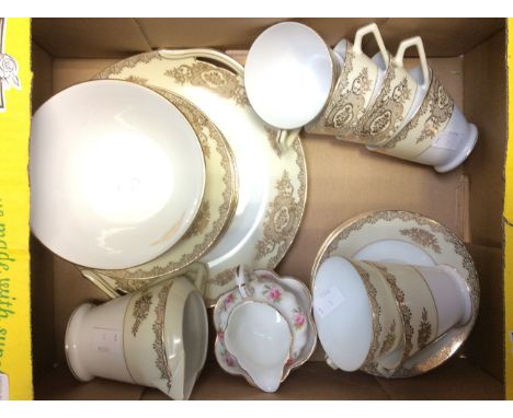 A Noritake ceramic six piece tea set, white ground with cream and gilt border, including cups, saucer, sugar and milk jug and