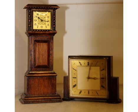 A mid 20th Century oak mantle clock, dated 1950, together with a further mantle clock in the form of a miniature longcase clo