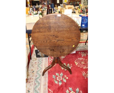 A Georgian oak tilt-top tripod table