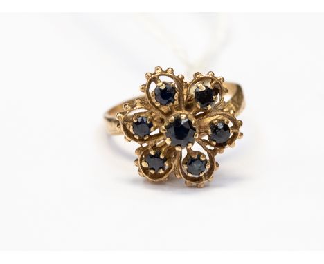 A nine carat gold and sapphire ring, open flower design, claw set with sapphires, head size approx 15mm, ring size N, total g