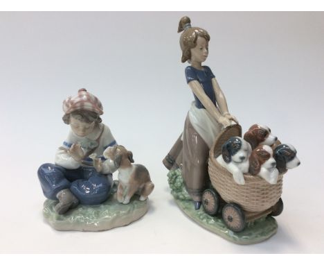 Two Lladro figures, girl with puppies and boy playing with puppies