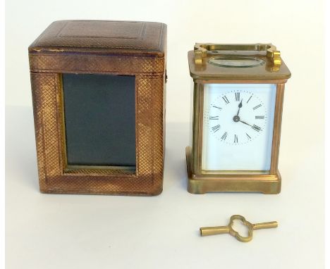 Brass carriage clock and key in travelling case. in working order