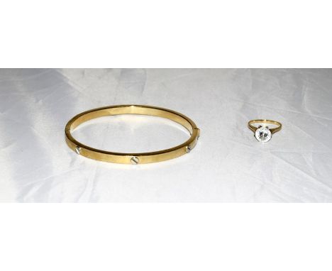 A Ladies' gold bangle together with a gold and aquamarine ring. Ring Size M