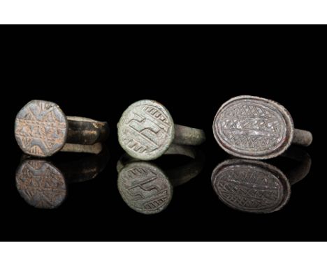 Ca. AD 1100 - 1400.A collection of medieval bronze rings. The first ring, on the left, has an angular, stepped D section hoop
