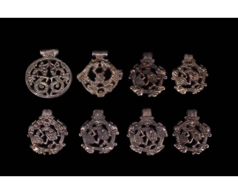 Ca. AD 900 - 1000.A set of eight silver pendants made via the open mould wax casting technique that was frequently used in th