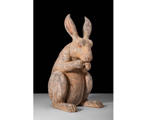Ca. 202 BC - AD 220. A Han dynasty terracotta rabbit. The rabbit is depicted standing upright on its hind legs and crouching 