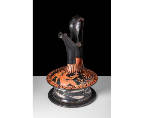 Ca. 350 - 300 BC.A black-glazed pottery epichysis with a spool-shaped base, domed shoulder and a tubular neck. A diagonally p