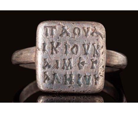 Ca. AD 700 - 1100. A Byzantine silver ring with a round hoop and a high square bezel, engraved with four lines of script in G