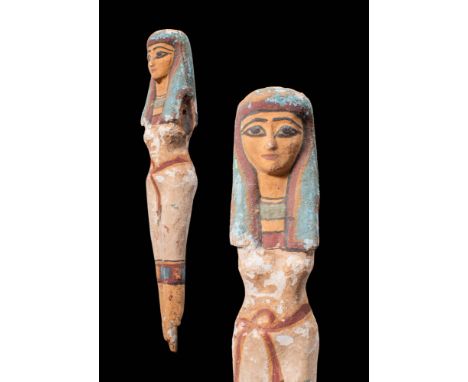 Ca. 1069 - 332 BC. A beautiful statue depicting a princess, carved from hardwood. The draped figure has thin hips and a sligh