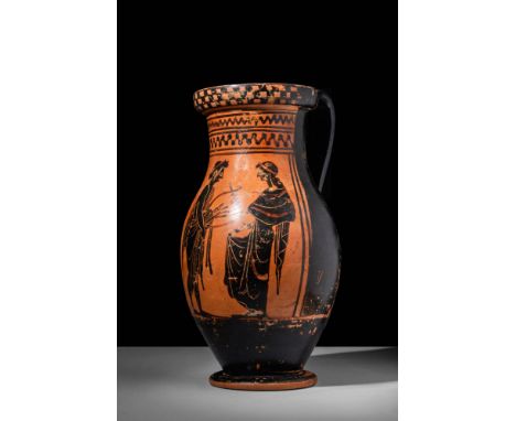 Ca. 550 - 500 BC.A fine black-figure Greek olpe. The vessel has a pear-shaped body connected to a large neck, which is decora