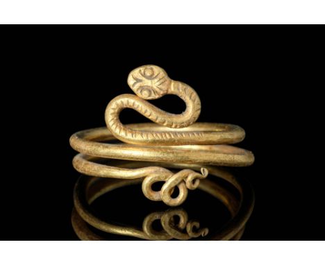 Ca. 100 BC - AD 200.An Egypto-Roman gold snake ring comprised of a long conical body adorned with incised scales only on the 