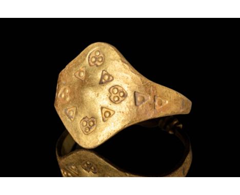 Ca. AD 800 - 1100.A Viking twisted gold ring comprising a flat hoop that is closed with a knot. The hoop widens on the should