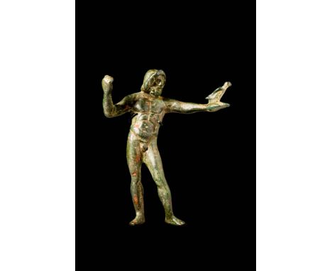 Ca. AD 100 - 300. A superb bronze figure of Jupiter exhibiting a muscular physique as he stands dynamically in counterpoise; 