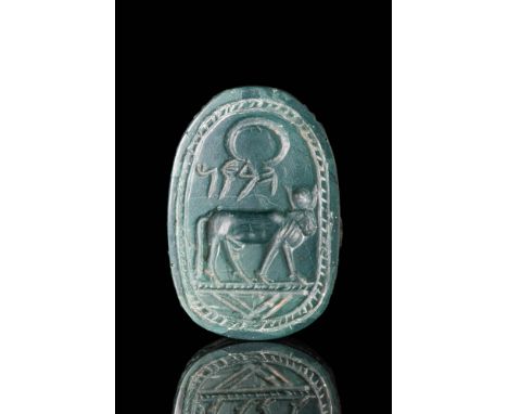 Ca. 700 - 500 BC.A green jasper scarab with a naturalistic featues. On the base is a fine image of the Apis bull that is surm