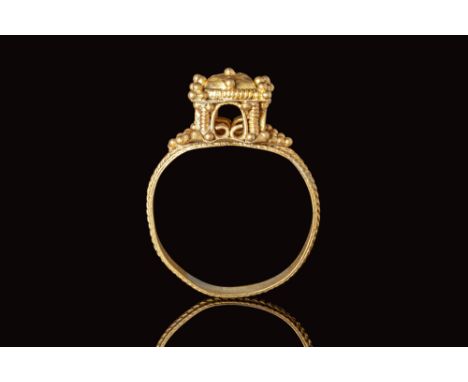 Ca. AD 500 - 700.A beautiful Byzantine architectural gold ring. The ring features a round, flat hoop decorated with geometric