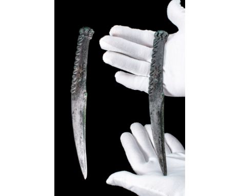 Ca. 700 - 500 BC. An Early Scythian bronze curved dagger decorated with grooves. This blade would have been capable of fulfil