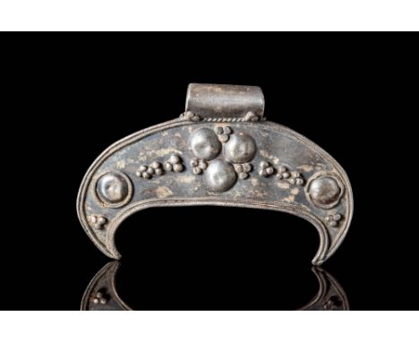 Ca. AD 800 - 1100.A Viking lunate pendant, shaped from silver into a crescent form, with three moulded pellets stippling the 